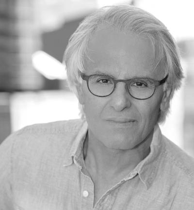 Man with white hair and glasses